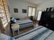 Bright bedroom with two beds, shutters, and a glimpse of the ocean view from a window at 121 Augusta Ave, Palm Harbor, FL 34683