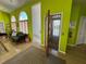 Inviting foyer with an elevator, wooden floors, and a sitting area perfect for welcoming guests at 121 Augusta Ave, Palm Harbor, FL 34683