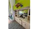 Wet bar with sink, white cabinets and view into an open concept living and dining room area at 121 Augusta Ave, Palm Harbor, FL 34683