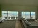 Bright living room features waterfront views, sliding glass doors, and comfortable seating at 121 Augusta Ave, Palm Harbor, FL 34683
