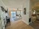 Bright living room with wood floors, shiplap accents, water views, and adjacent access to the bathroom at 121 Augusta Ave, Palm Harbor, FL 34683