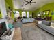 Spacious living room with bright green walls, wood floors, and plenty of room to relax and entertain at 121 Augusta Ave, Palm Harbor, FL 34683