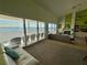 Bright living room with an ocean view, white brick fireplace and modern decor at 121 Augusta Ave, Palm Harbor, FL 34683