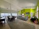 Expansive living space with water view, featuring a dining set, a large sectional and colorful walls at 121 Augusta Ave, Palm Harbor, FL 34683
