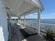 Inviting porch with furniture set, offering a great space for enjoying waterfront views and relaxation at 121 Augusta Ave, Palm Harbor, FL 34683