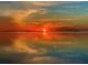 Beautiful water view with a vibrant orange and red sunset reflection at 121 Augusta Ave, Palm Harbor, FL 34683