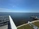 Waterfront property featuring a water view and easy access to boat lifts and a white decorative railing at 121 Augusta Ave, Palm Harbor, FL 34683