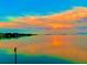 Sunset view over the calm water, creating a serene and picturesque waterfront scene during a colorful sunset at 121 Augusta Ave, Palm Harbor, FL 34683