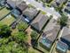 Aerial view of neighborhood homes featuring screened in pools and spacious backyard areas at 1250 Halapa Way, Trinity, FL 34655