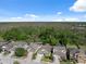 Birds eye view of neighborhood homes backed by natural Florida landscape and bright blue skies at 1250 Halapa Way, Trinity, FL 34655