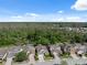 Aerial view of neighborhood homes with a view of forest behind homes in the distance at 1250 Halapa Way, Trinity, FL 34655