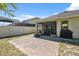 Brick patio leading to a screened in porch and large grill in this ample backyard at 1250 Halapa Way, Trinity, FL 34655