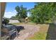 Backyard with brick patio, chairs, fire pit, playground, and fenced perimeter at 1250 Halapa Way, Trinity, FL 34655