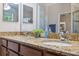 Bathroom featuring double sinks with granite counters, providing ample space and style at 1250 Halapa Way, Trinity, FL 34655