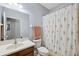 Bathroom with vanity, toilet, and shower with floral shower curtain at 1250 Halapa Way, Trinity, FL 34655