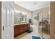 Bathroom with double vanity, soaking tub, glass enclosed shower, and tile flooring at 1250 Halapa Way, Trinity, FL 34655