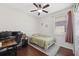 Cozy bedroom with hardwood floors and natural light, complete with a desk and ample space at 1250 Halapa Way, Trinity, FL 34655
