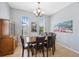 Inviting dining room with tile floors, large windows, and a classic chandelier at 1250 Halapa Way, Trinity, FL 34655