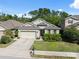 Street view of a single-Gathering home with a well-manicured lawn and attached two-car garage at 1250 Halapa Way, Trinity, FL 34655