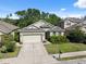 Charming single-story home with a well-manicured lawn and a two-car garage at 1250 Halapa Way, Trinity, FL 34655