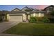 Charming home with well-maintained lawn and attached garage at 1250 Halapa Way, Trinity, FL 34655