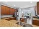 Kitchen with stainless appliances, granite countertops, and a view of the dining area at 1250 Halapa Way, Trinity, FL 34655