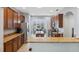 Well-lit kitchen with stainless steel appliances, wooden cabinets, and granite countertops at 1250 Halapa Way, Trinity, FL 34655