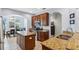 Bright kitchen features an island, stainless appliances, and a view into the dining area at 1250 Halapa Way, Trinity, FL 34655