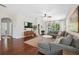 Comfortable living room featuring hardwood floors, ceiling fan, and access to other areas of the home at 1250 Halapa Way, Trinity, FL 34655