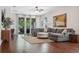 Spacious living room with hardwood floors, natural lighting, and stylish furniture at 1250 Halapa Way, Trinity, FL 34655