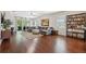 Bright, open living room showcasing hardwood floors, a ceiling fan, and a large comfortable sofa at 1250 Halapa Way, Trinity, FL 34655