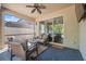 Screened patio with seating and ceiling fan at 1250 Halapa Way, Trinity, FL 34655