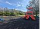 Community playground features a climbing structure, swings, slides and safety mulch at 1250 Halapa Way, Trinity, FL 34655