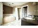 Bathroom featuring a tub, dual sinks, and a closet at 13066 Painted Bunting Ave, Weeki Wachee, FL 34614