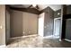 Neutral bedroom with a ceiling fan, and tile flooring, offers a bright and airy space at 13066 Painted Bunting Ave, Weeki Wachee, FL 34614
