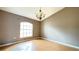 Dining room with wood floors, a chandelier, and a large window at 13066 Painted Bunting Ave, Weeki Wachee, FL 34614