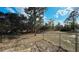 Fenced backyard providing a secure space with views of mature trees and surrounding landscape at 13066 Painted Bunting Ave, Weeki Wachee, FL 34614