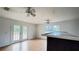 Living room showcasing wood laminate flooring, a bar, and large windows at 13066 Painted Bunting Ave, Weeki Wachee, FL 34614