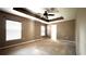 Spacious main bedroom boasts decorative ceiling, two windows, and ample natural light at 13066 Painted Bunting Ave, Weeki Wachee, FL 34614