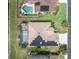 Overhead shot showcasing a pool, solar panels, and meticulously maintained lawn in a residential area at 1709 Nodding Thistle Dr, New Port Richey, FL 34655