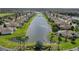 An aerial view of a residential area with beautiful houses surrounding a long, calm lake at 1709 Nodding Thistle Dr, New Port Richey, FL 34655
