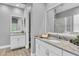 Bathroom featuring dual sinks, granite countertops, a large mirror, and a glass enclosed shower at 1709 Nodding Thistle Dr, New Port Richey, FL 34655