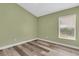 Bedroom featuring wood-look floors and a bright window at 1709 Nodding Thistle Dr, New Port Richey, FL 34655