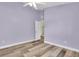 Neutral bedroom featuring wood-look floors, a ceiling fan, and a closet for storage at 1709 Nodding Thistle Dr, New Port Richey, FL 34655