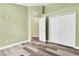 Bedroom with wood-look floors and neutral walls at 1709 Nodding Thistle Dr, New Port Richey, FL 34655