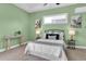 Bright bedroom with serene green walls, neutral carpet, and a comfortable queen-size bed at 1709 Nodding Thistle Dr, New Port Richey, FL 34655