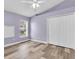 Cozy bedroom with wood-look floors, a ceiling fan, and a closet for storage at 1709 Nodding Thistle Dr, New Port Richey, FL 34655