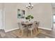 Dining room with wood floors, neutral paint, contemporary chandelier and seating for six at 1709 Nodding Thistle Dr, New Port Richey, FL 34655