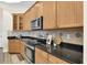 Charming kitchen includes custom cabinets, stainless steel appliances, and granite countertops at 1709 Nodding Thistle Dr, New Port Richey, FL 34655