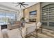 Cozy living room boasts a fireplace, pool view, and open access to the outdoor living at 1709 Nodding Thistle Dr, New Port Richey, FL 34655